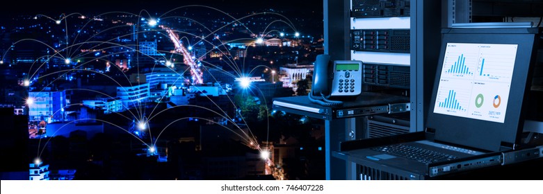 Management And Monitoring Monitor In Data Center And Connectivity Lines Over Night City Background, Smart City Concept