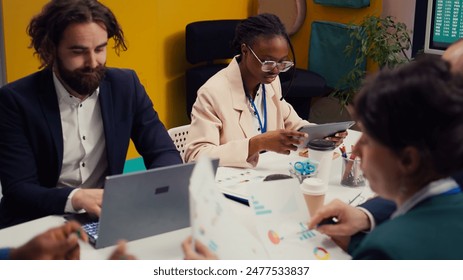 Management team developing new digital transformation initiatives in a boardroom meeting, enhance operational efficiency and agility. Employees improve organization workflow and performance. Camera B.