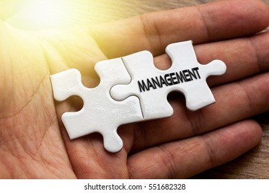 MANAGEMENT written on White color of jigsaw puzzle with hand,conceptual - Shutterstock ID 551682328