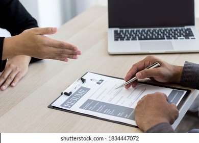 The manager is about to shake hands with the job applicant after the interview has finished. - Shutterstock ID 1834447072
