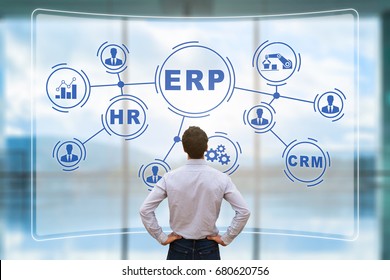 IT manager analyzing the architecture of ERP (Enterprise Resource Planning) system on virtual AR screen with connections between business intelligence (BI), production, HR and CRM modules