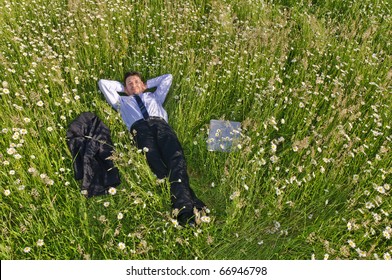 Manager, Business Man Lying In The Middle Of A Field Of Flowers And More Relaxed, His Jacket Is Next To Him