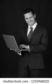 Manager, Businessman Or Happy Man Smiling With Laptop On Black Background. Formal Blue Suit And Tie. Technology For Business. Fashion And Dress Code