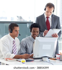 Manager And Businessmen Working In Call Center With A Headset On