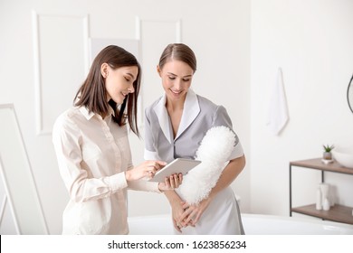 Manager And Chambermaid In Hotel Bathroom