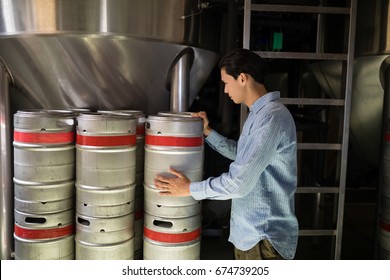 Manager checking beer keg in warehouse of restaurant - Powered by Shutterstock