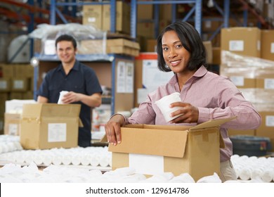 Manager Checking Goods On Production Line
