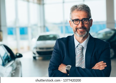 Manager Crossed Arms In Car Showroom