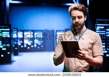 Manager in data center walking through server racks used for computationally intensive tasks such as quantum mechanics or weather forecasting. Specialist running annual equipment diagnosis