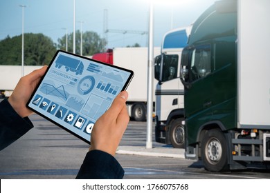 Manager With A Digital Tablet On The Background Of Trucks. Fleet Management