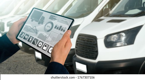 Manager With A Digital Tablet On The Background Of Trucks. Fleet Management