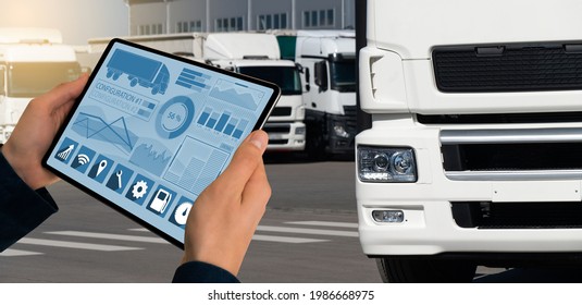 Manager With A Digital Tablet On The Background Of Trucks. Fleet Management