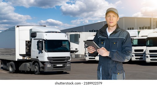 Manager With A Digital Tablet On The Background Of Trucks. Fleet Management