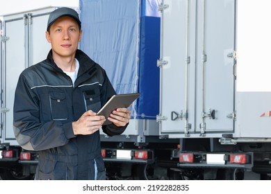 Manager With A Digital Tablet On The Background Of Trucks. Fleet Management