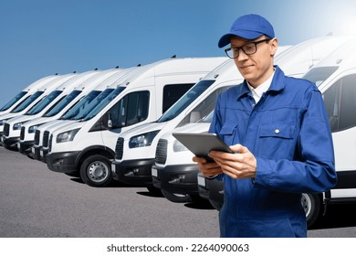 Manager with a digital tablet on the background of vans. Fleet management - Powered by Shutterstock