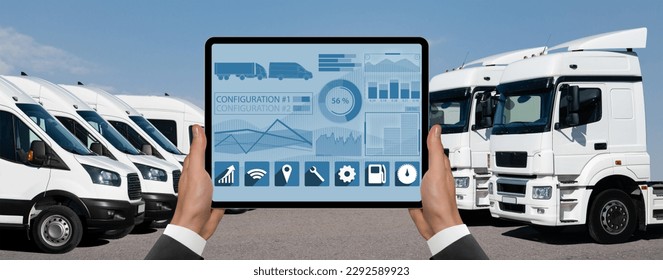 Manager with a digital tablet on the background of vans and trucks. Fleet management
