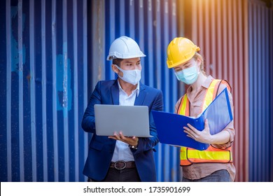 Manager and dock worker under discussion about dock container shipping warehouse document, they wearing safety uniform hard hat ,face mask and hold radio communication. - Shutterstock ID 1735901699