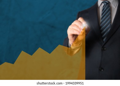 Manager drawing a chart or graph with a marker, smbolizing growing trend of stock value, shares, revenue or customer orders