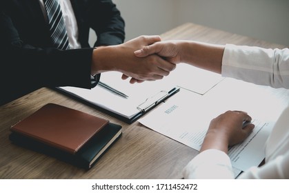 Manager And Employee Interview Concept With Handshake After Talking About Contract Signing.