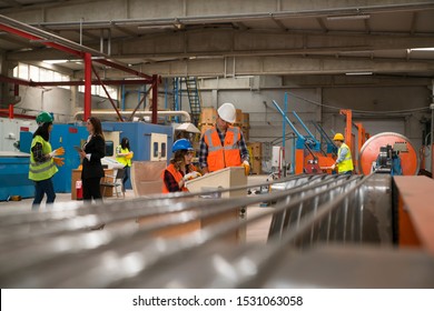 Manager And Factory Employees Working Together To Get The Job Done, Copy Space