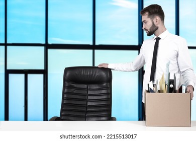 Manager Fired. Man Manager With Box Of Fired Employee. Sad Man Leader Of Company. Fired Manager Looks At Empty Chair. Concept Staff Reduction. Metaphor Of Layoffs Due To Poor Business Performance