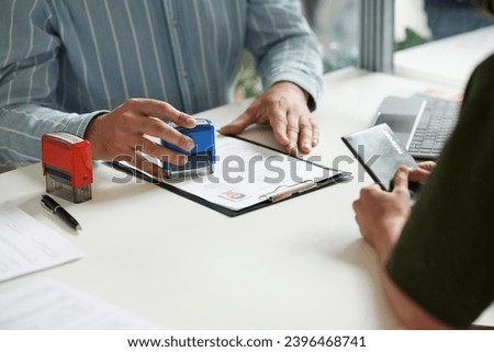 Manager giving visa to client