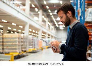 Manager holding digital tablet in warehouse - Shutterstock ID 1111897943