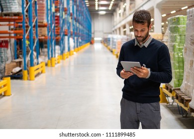 Manager holding digital tablet in warehouse - Shutterstock ID 1111899485