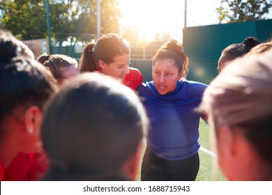 Manager In Huddle With Womens Football Team Giving Motivational Pep Talk Before Soccer Match