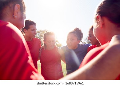 Manager In Huddle With Womens Football Team Giving Motivational Pep Talk Before Soccer Match