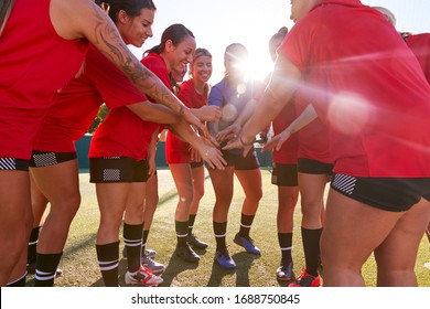 Manager Joining Hands With Womens Soccer Team During Pep Talk Before Match