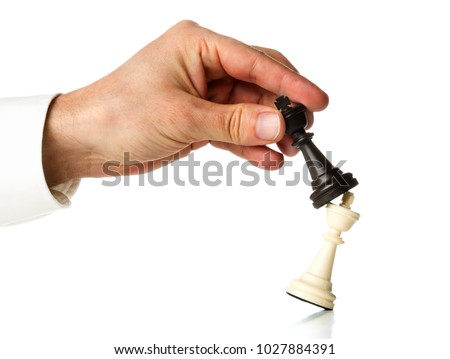 Manager knocking over one chess king figure with another king chess figure - leadership, takeover, promotion or strategy concept over white background