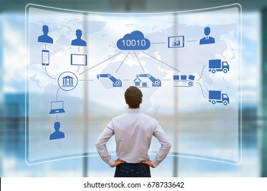Manager looking at augmented reality (AR) screen showing smart factory or industry 4.0 automated manufacturing connected with internet of things (IOT) and cloud computing - Powered by Shutterstock - Get 15% off with code: PIKWIZARD15