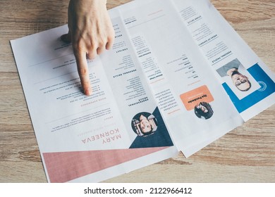  Manager looking at many different cv resume and choosing perfect person.  - Shutterstock ID 2122966412