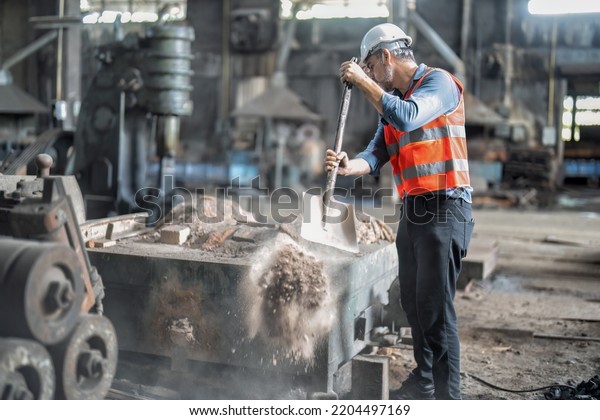 Manager in the\
maintenance steel factory repair shop house keeping cleanning soil\
dust from the furnace
