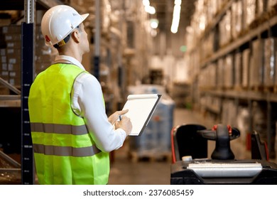 Manager man worker doing stocktaking of product management on shelves in warehouse. Physical inventory count. Male professional assistant checking controlling the stock in factory.