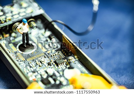 Manager Miniture People Standing and looking to the electronic circuit board, Electronic waste management concept use.. Copy space on blue background.