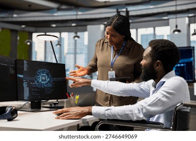 Manager overseeing tasks progress done by worker with paraplegia using AI to fix glitches. Team leader supervising programmer in wheelchair using artificial intelligence to do optimizations