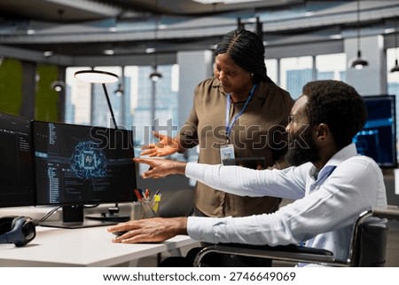 Manager overseeing tasks progress done by worker with paraplegia using AI to fix glitches. Team leader supervising programmer in wheelchair using artificial intelligence to do optimizations