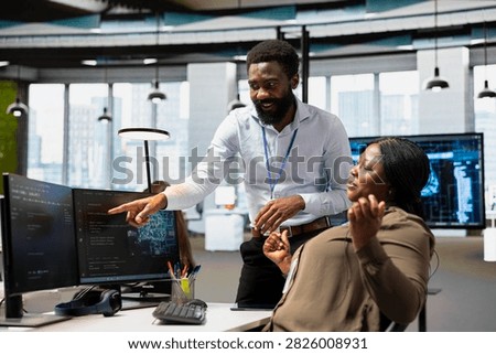 Manager oversees an AI development project in the office, guiding an employee through machine learning tasks and neural network implementation