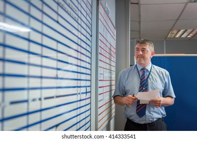 Manager presenting figures in meeting in engineering factory - Powered by Shutterstock