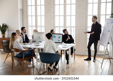 Manager Presenting Sales Report To Office Colleagues. Leader Giving Presentation To Employees At Corporate Meeting. Business Coach Training Staff. Workshop, Presentation Concept