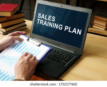 Manager Reads Sales Training Plan In The Laptop.