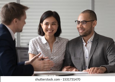 Manager Realtor Banker Consulting Happy Diverse Young Couple At Meeting, Asian Woman And African American Man Taking Loan, Mortgage Or Insurance, Purchase Real Estate, Negotiations Concept