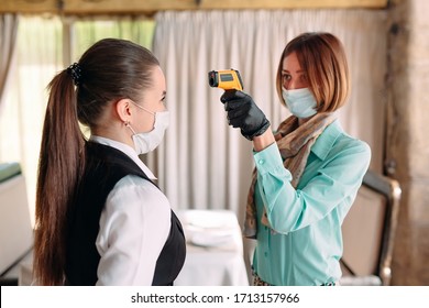 The Manager Of A Restaurant Or Hotel Checks The Body Temperature Of The Staff With A Thermal Imaging Device