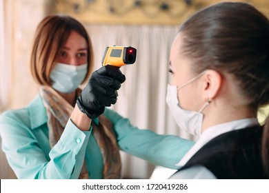 The Manager Of A Restaurant Or Hotel Checks The Body Temperature Of The Staff With A Thermal Imaging Device