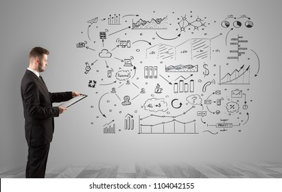 Manager staying and presenting office affairs for someone with graphs, icons reports around - Shutterstock ID 1104042155