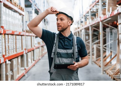 Manager Is In The Store. Employee In Uniform Is Working In The Storage At Daytime.