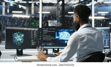 Manager supervising data center engineer using AI neural network models to configure hardware. Team leader overseeing employee using machine learning programming language to optimize systems, camera B
