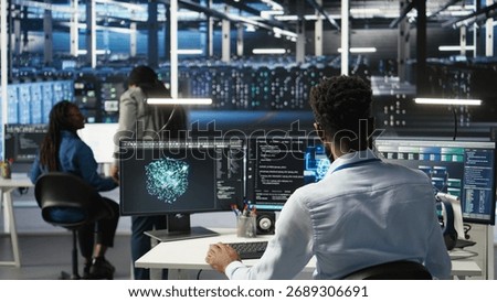 Manager supervising data center engineer using AI neural network models to configure hardware. Team leader overseeing employee using machine learning programming language to optimize systems, camera A